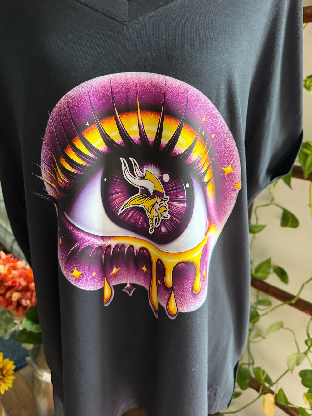 Minnesota Vikings Black Tee with Purple & Yellow Dripping Eye Graphic